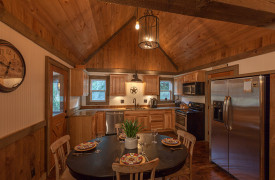 Cherokee Sunrise on Noontootla Creek | Cabin Rentals of Georgia | spacious kitchen and dining with cathedral ceiling and Restoration Hardware lighting in a renovated 110 year old farmhouse in North Georgia Mountains