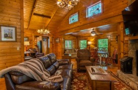 Creekside Green | Cabin Rentals of Georgia | Conversational Seating in Living Area with TV and Dining Area for 6