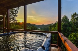 Riverview Lodge | Cabin Rentals of Georgia | Hot Tub at sunset overlooking North GA Mountains and Toccoa River meandering through the mountains