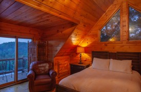 Riverview Lodge | Cabin Rentals of Georgia | Upper Level Queen Suite with luxury linens and access to third floor balcony overlooking panoramic mountain views and Toccoa River