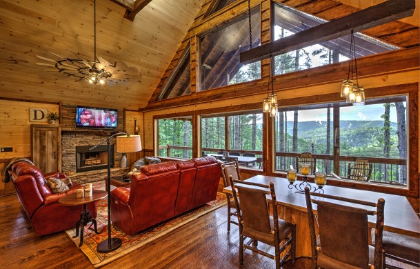 Above the Timberline | Cabin Rentals of Georgia | Luxury Living Area and Dining area with wall of windows looking at North GA Mountain views in daytime