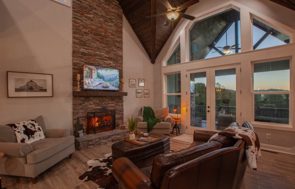 Skyfall | Cabin Rentals of Georgia | Luxury living area with fireplace and TV overlooking mountain view